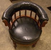 A Victorian leather upholstered walnut tub desk chair
The studded padded back above turned