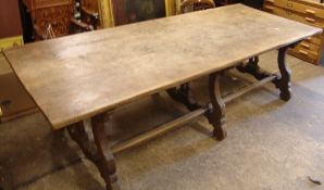 A 19th century Continental walnut refectory trestle table
The rectangular top supported on scrolling