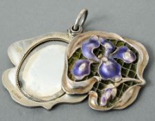 A French Art Nouveau silver and enamel decorated pendant mirror
The sliding front with enamel floral