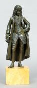 A 19th century patinated bronze figure
Formed as a well dressed gentleman holding a book, standing