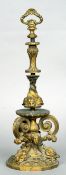 A 19th century cast gilt bronze door stop
The pierced handle above the slender column decorated with