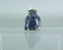 An Eastern carved lapis lazuli and yellow metal mounted pendant
Modelled as a figure wearing a