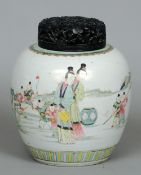 A Chinese porcelain ginger jar and pierced wood cover
Decorated with figures and playing children in