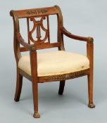 A 19th century Empire style gilt metal mounted mahogany child's open armchair
The scrolling gilt