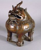 A fine 17th century Chinese bronze censor
In the form of a  horned mythical beast, with gilded
