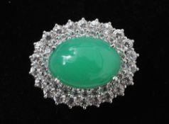 A fine quality 18 ct white gold, jade and diamond ring
The central jade cabochon bordered by two