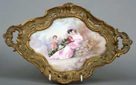 A 19th century Sevres style painted porcelain plaque
Decorated with cupid beside two young ladies