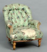 A Victorian upholstered button back armchair
The curved top rail above twin padded arms and the