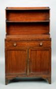 A Regency mahogany bonheur du jour
The galleried top tier above a central shelf and the hinged baize