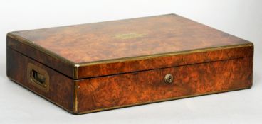 A Victorian brass bound burr walnut humidor
The brass banded hinged rectangular top centred with