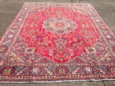 A Tabriz wool carpet
The wine red field enclosing a  central medallion with pendant palmettes within
