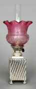 An early 20th century silver plated oil lamp
The square section base marked for Walker & Hall;