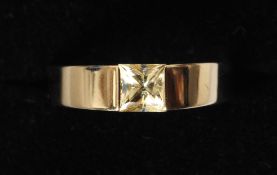 An 18 ct gold yellow sapphire ring
With centrally set princess cut stone.   CONDITION REPORTS: