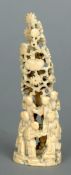 A Chinese carved and pierced ivory group
Modelled as figures beneath a floral bocage.  15 cms high.