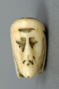 An unusual small early bone twin headed pendant
One side depicting the face of Christ, the other a