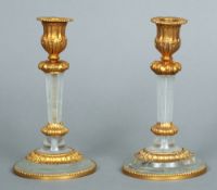 A pair of gilt bronze mounted rock crystal candlesticks
Each 19 cms high.  (2)   CONDITION REPORTS: