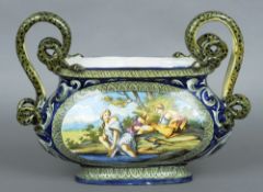 A 19th century faience jardiniere
The squat bulbous body painted with figures in a landscape,