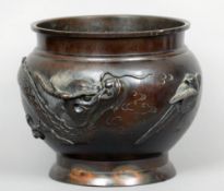 A late 19th century Japanese patinated bronze jardiniere
The plain flared neck rim above the bulbous