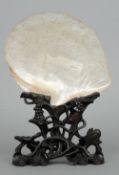 A 19th century Cantonese carved oyster shell
One side profusely carved with figures and pagodas