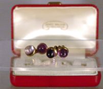 A pair of yellow metal amethyst set cufflinks
Indistinctly hallmarked, in fitted case for James