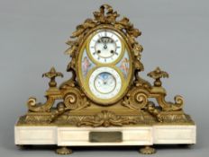 A 19th century gilt bronze and marble mantel clock
The ribbon tied and floral swag mounted oval face