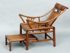 A Chinese plantation chair
The pierced back splat above the moveable seat and foot rest.  85 cms