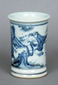 A Chinese blue and white brush pot
The cylindrical body decorated with figures in a garden.  14