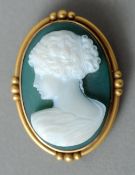 A 14 ct gold mounted hardstone cameo brooch
The front carved with the bust of a classical maiden.  4