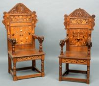 A pair of his and hers inlaid and carved oak open armchairs
Each carved pediment above panels inlaid