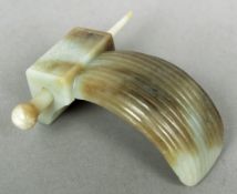 A Chinese carved russet jade hair clip
Of typical form, the carved base with applied pin.  9 cms