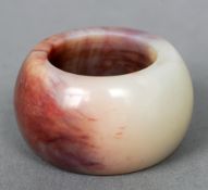A Chinese jade ring
Of domed form.  3 cms diameter.   CONDITION REPORTS:  Overall good.