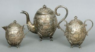 A Chinese unmarked silver three piece tea set
Comprising: teapot, sugar bowl and milk jug, each