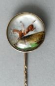 A Victorian unmarked gold mounted Essex crystal tie pin
The circular head decorated with a jumping