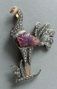 An unmarked gold backed peacock formed brooch
Set with rose quartz and diamonds.  6 cms high.