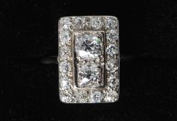 An Art Deco 18 ct gold and platinum diamond set ring
With two centrally set diamonds bordered by a