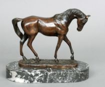 A patinated bronze model of a horse
Naturalistically modelled standing on a domed base and a