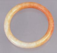 A russet jade bangle
Of tubular form. 8.25 cms diameter.   CONDITION REPORTS:  Overall good.