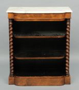 A Victorian marble topped rosewood open bookcase 
The shaped marble top above a plain frieze over