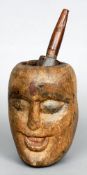 An unusual 19th century treen pestle and mortar
The mortar carved to either side with a face with
