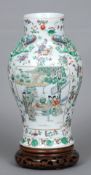 A Chinese porcelain vase 
Decorated with figural vignettes within floral sprays interspersed with