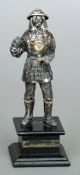 A small Japanese silver model of a samurai 
Modelled standing on a black plinth base.  16.5 cms