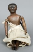 An early carved wooden peg doll
Typically formed and jointed, with traces of original painted