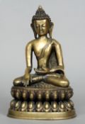 A cast bronze model of Buddha
Seated in a lotus position wearing a headdress.  23 cms high.