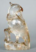 A rock crystal carved bird
Modelled standing on rockwork, a flower in its beak.  9 cms high.