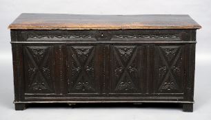 An 18th century oak panelled coffer
The hinged moulded rectangular lid above the carved four panel
