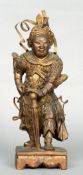 A 19th century carved figure of a warrior
Modelled standing on a plinth base, with gilt and red