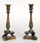 A pair of Regency bronze candlesticks
Each urn form sconce above the acanthus cast stem, standing on