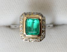 An Art Deco emerald, diamond and platinum ring
The central emerald bordered by a row of small