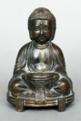 An Eastern bronze figure of a seated Buddha
Modelled seated holding a bowl, three character