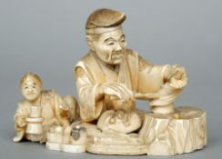 A 19th century Japanese carved ivory okimono
The figural group formed as a craftsman making a puppet